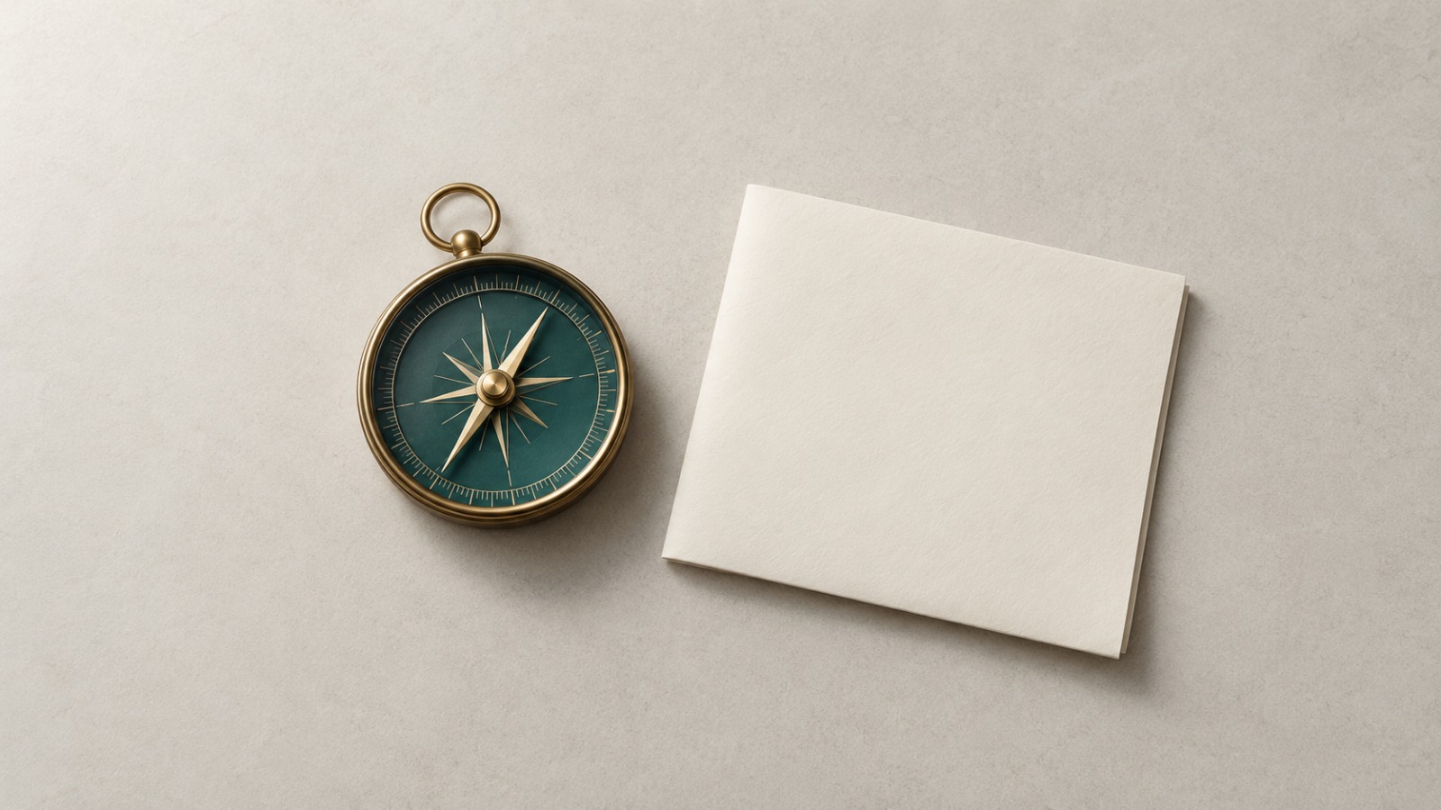 A compass beside a blank card representing clear direction